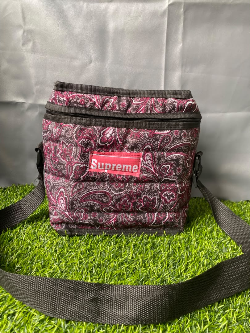 Supreme-branded quilted cooler bag with a pink and black paisley pattern