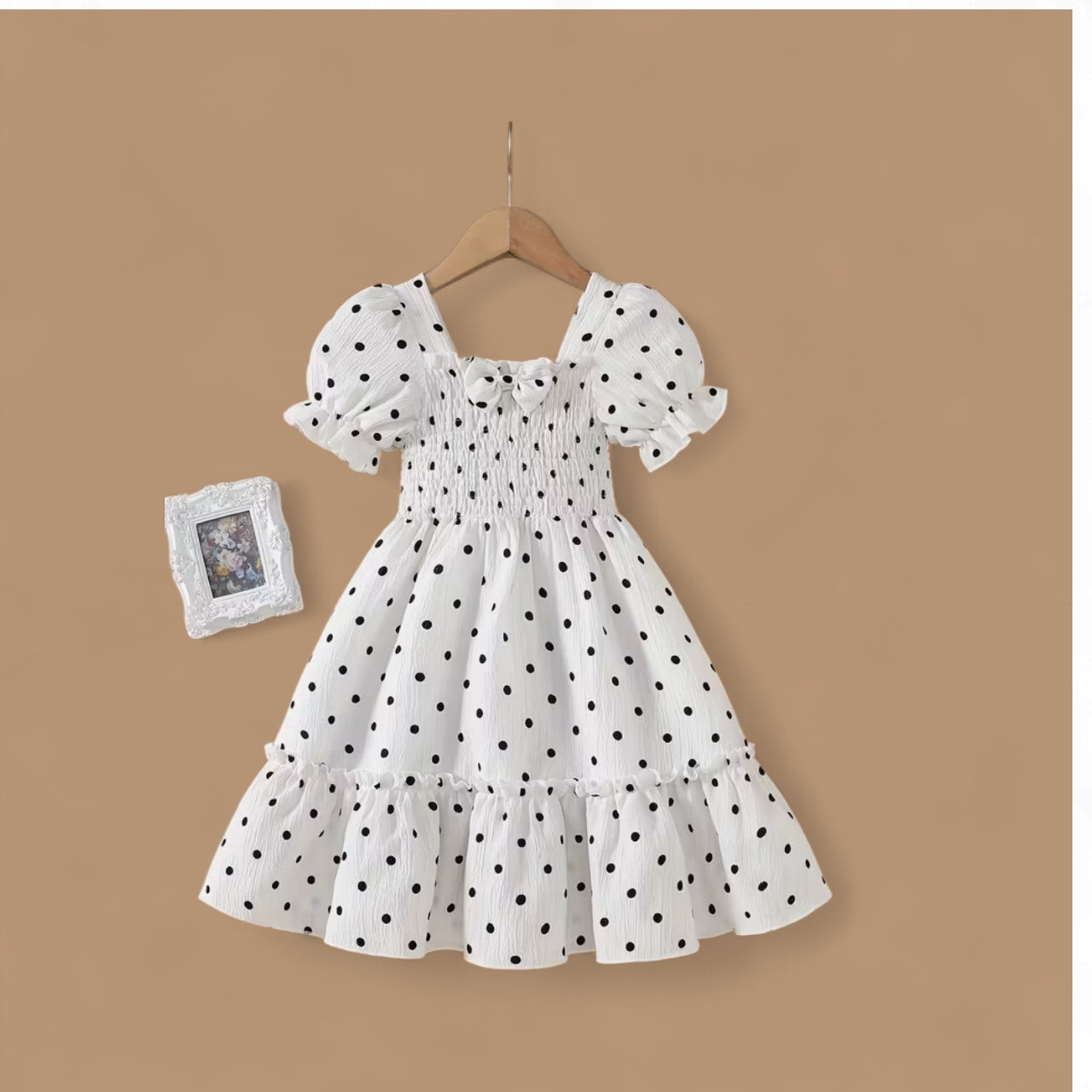 White toddlers dress with black polka dots