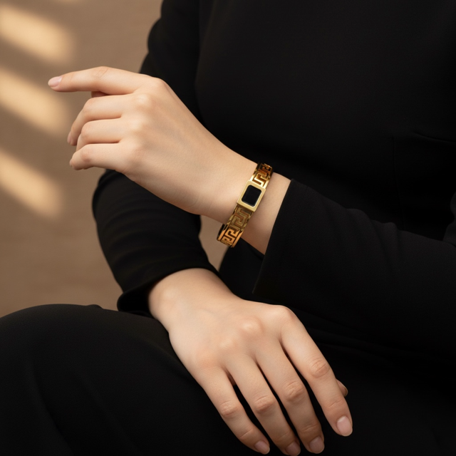 Gold bracelet with a black square clasp